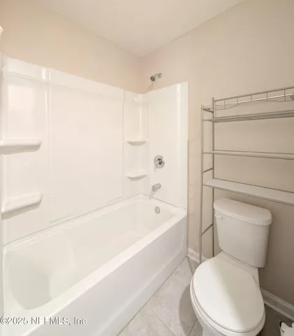 a bathroom with a toilet and a bathtub