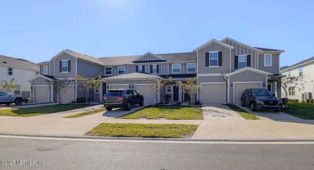 a view of a house with a patio and a yard