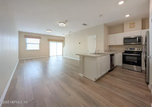 a kitchen with stainless steel appliances granite countertop a stove top oven and sink