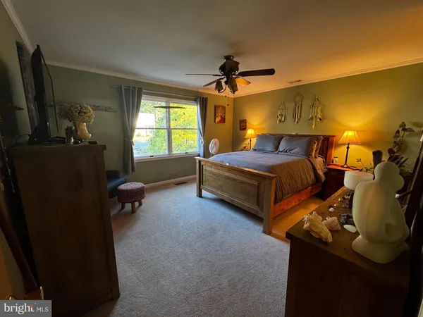 a bedroom with bed and a window
