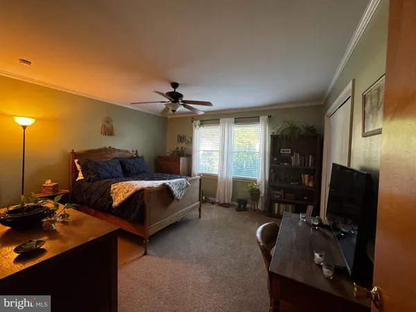 a bedroom with furniture and a flat screen tv
