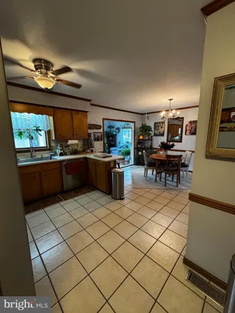 a kitchen with stainless steel appliances kitchen island granite countertop a refrigerator and a stove top oven