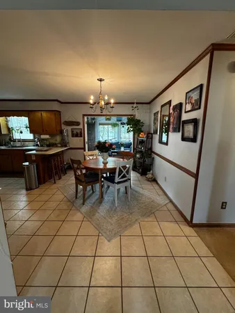 a living room with furniture a flat screen tv and kitchen view