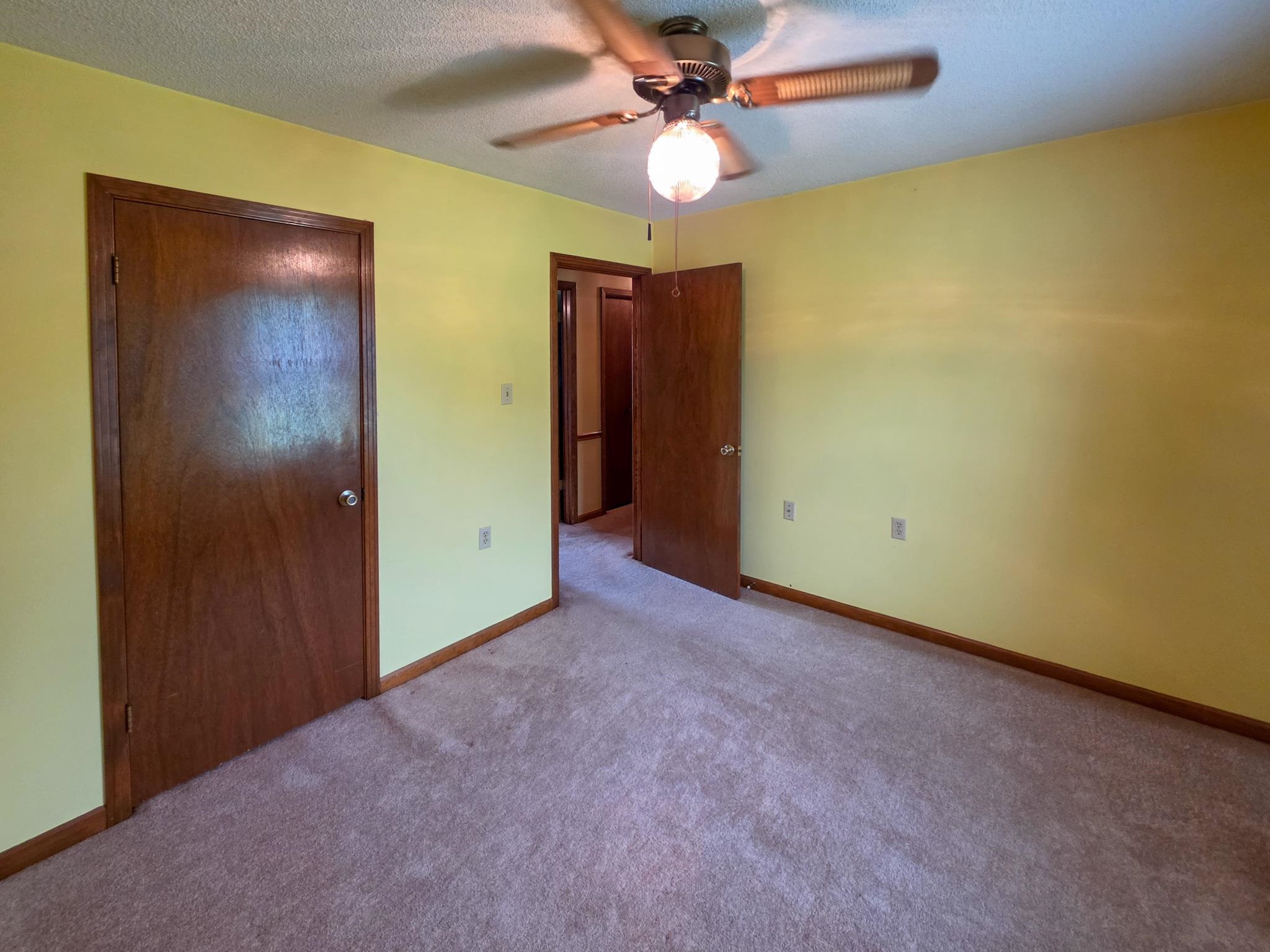 966 Beaver Road Munford, TN 38058 - Photo 15 of 32 Carpeted interior room featuring a ceiling fan with light fixture, wood-finish doors, and baseboard trim