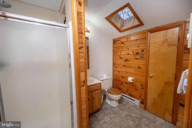 a bedroom with a bed and ceiling fan