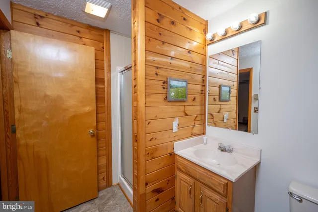 a bedroom with bed and wooden floor