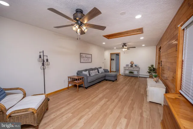 a living room with furniture pool table and a flat screen tv