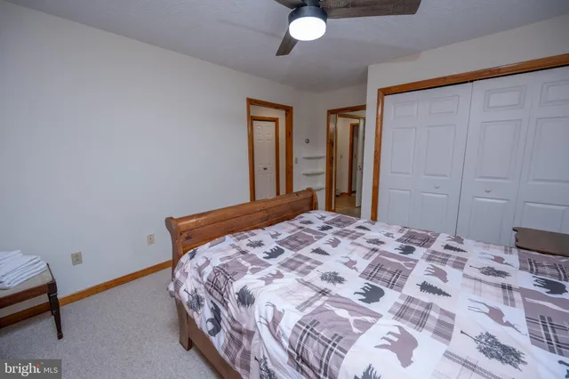 a hallway with a large window and furniture
