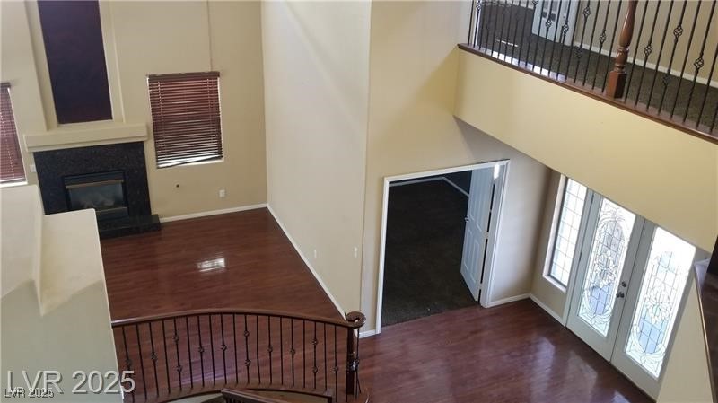 7414 Page Ranch Court Las Vegas, NV 89131 - Photo 13 of 36 Foyer entrance featuring dark wood finished floors, a high ceiling, and a glass covered fireplace