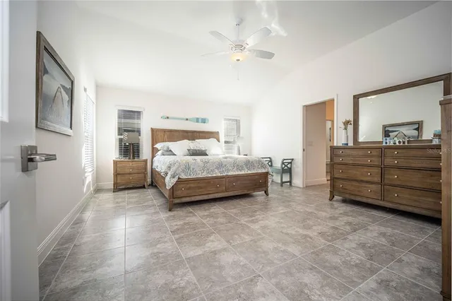 a bedroom with a bed and a ceiling fan