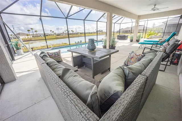 a living room with furniture and a floor to ceiling window