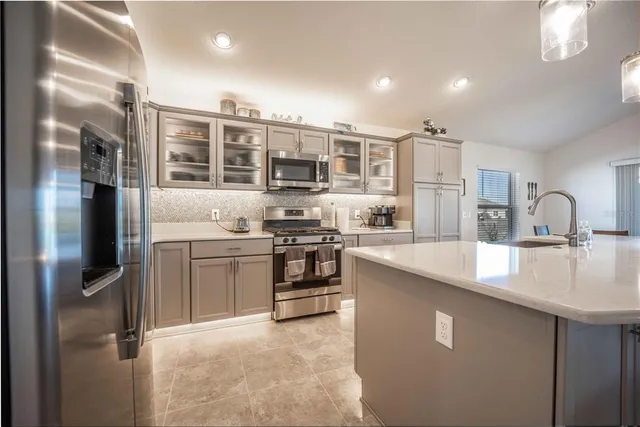 a large kitchen with a lot of counter space and appliances