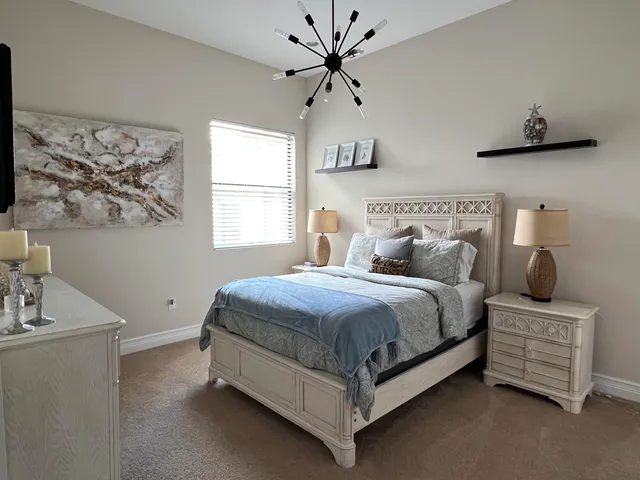 a bedroom with a bed and ceiling fan