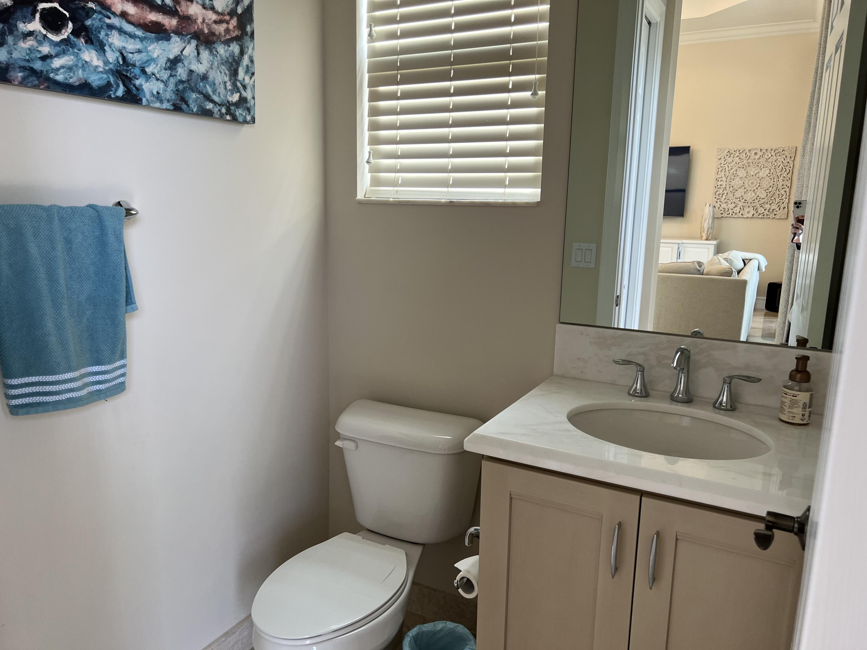16831 Pavilion Way Delray Beach, FL 33446 - Photo 17 of 26 a bathroom with a granite countertop toilet a sink and a mirror