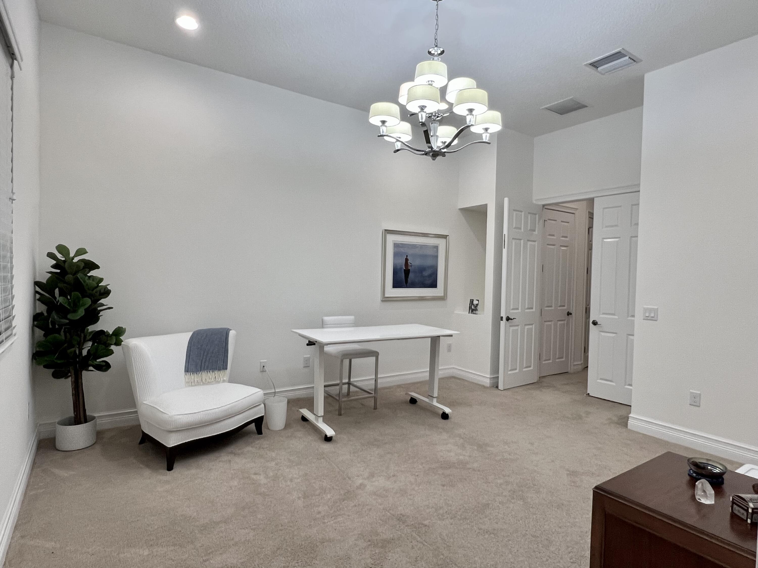 16831 Pavilion Way Delray Beach, FL 33446 - Photo 18 of 26 a living room with furniture and a chandelier