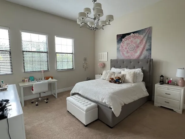 a bedroom with a bed and a chandelier