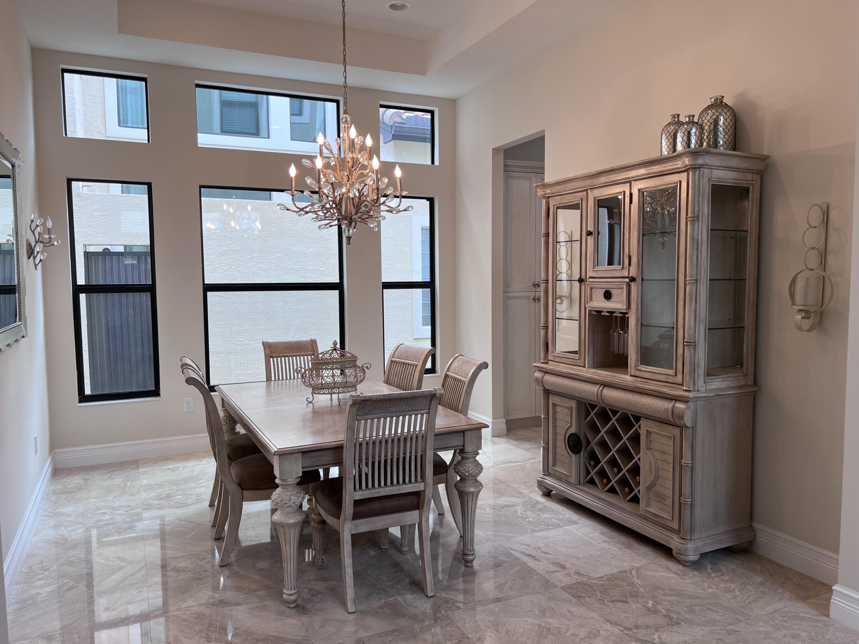 16831 Pavilion Way Delray Beach, FL 33446 - Photo 6 of 26 a view of a dining room with furniture and chandelier