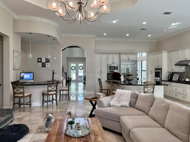 a living room with furniture and a chandelier
