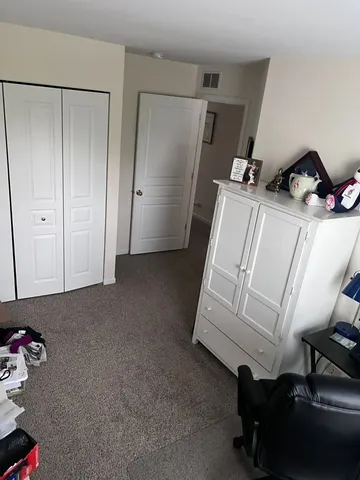 a room with a chair and white walls