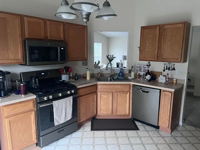 a kitchen with a sink stove and microwave