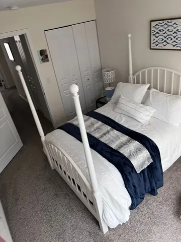 a bedroom with a bed and a walk in closet