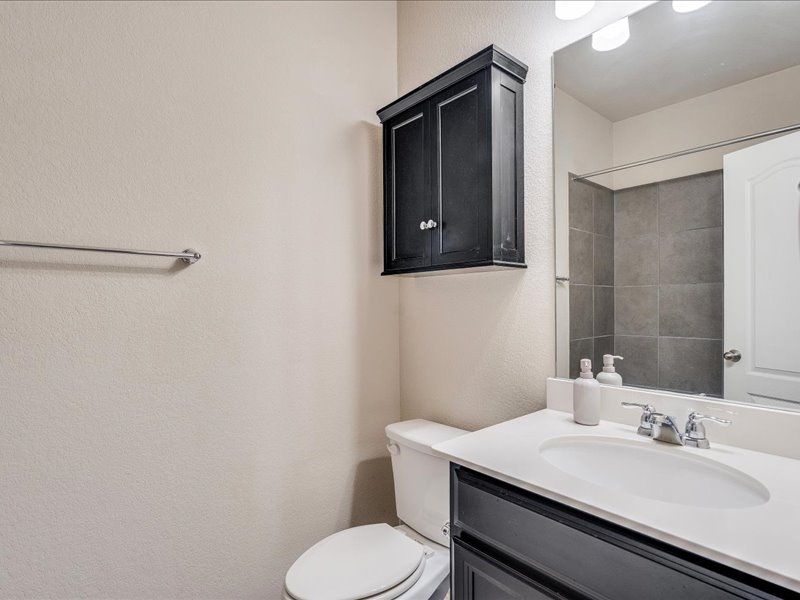 22005 Rhiannon Lane Pflugerville, TX 78660 - Photo 11 of 21 a bathroom with a sink toilet and mirror