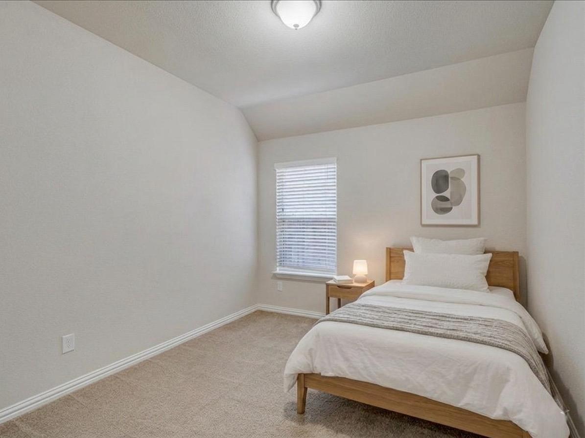 22005 Rhiannon Lane Pflugerville, TX 78660 - Photo 12 of 21 a bedroom with a bed and a window