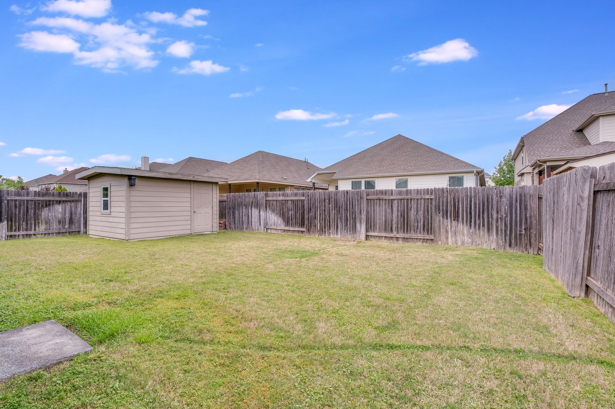 22005 Rhiannon Lane Pflugerville, TX 78660 - Photo 16 of 21 a view of a house with a yard and wooden fence
