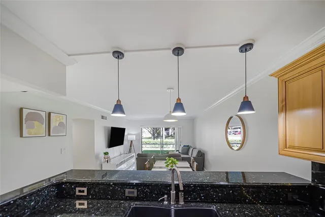 a living room with furniture appliances and a window