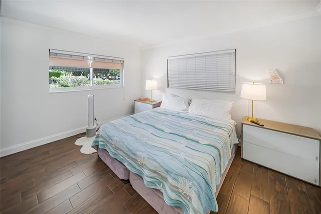 a bedroom with a bed and a painting on the wall