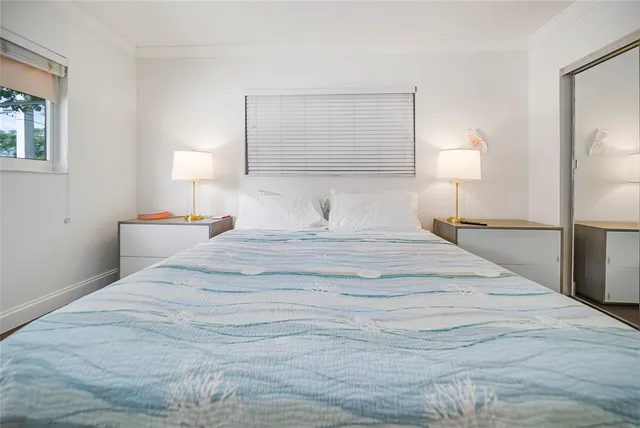 a bedroom with a bed and a night stand