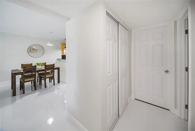 a view of a kitchen with table and chairs