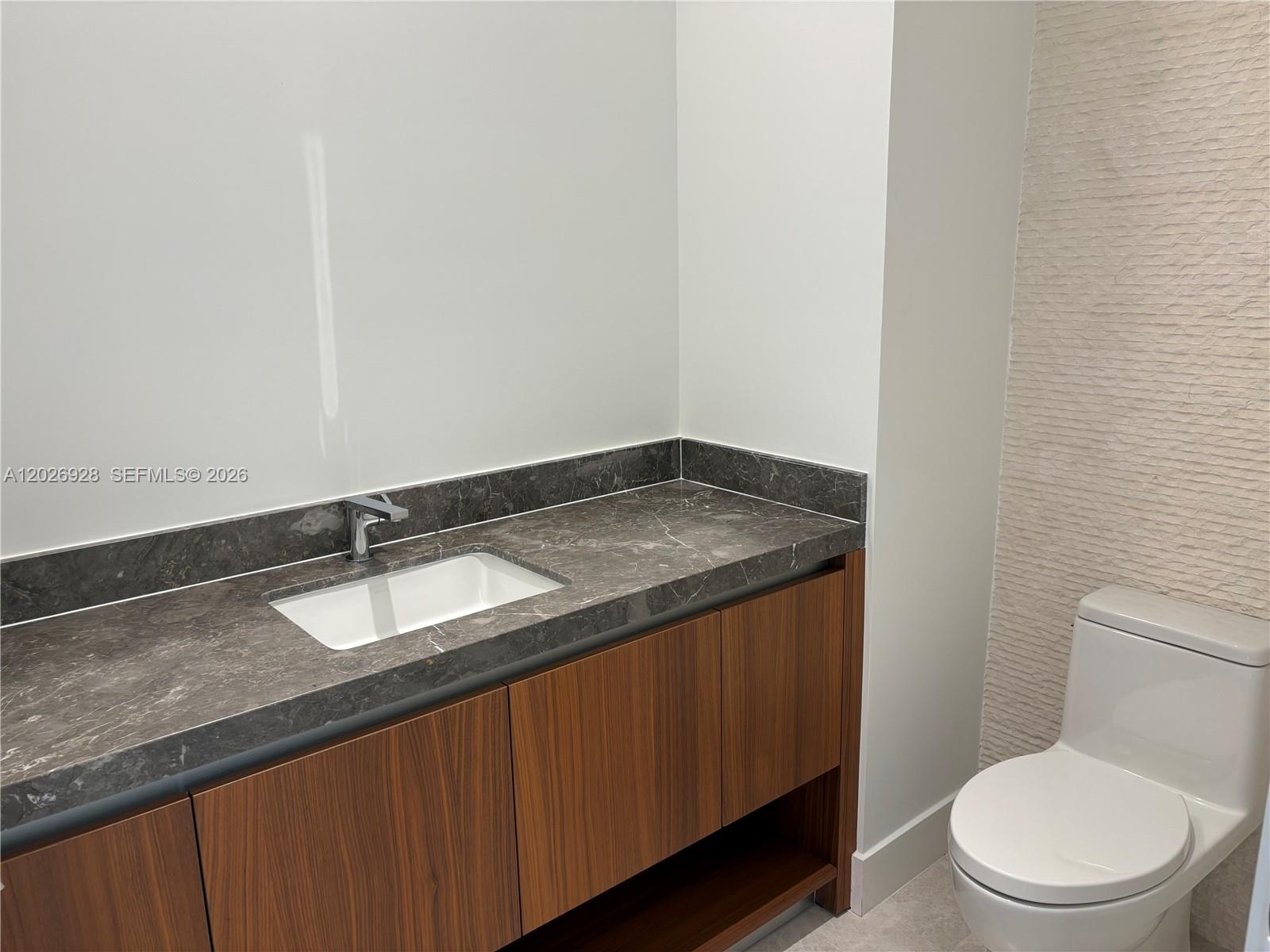 175 Southeast 25th Road, Unit 901 Miami, FL 33129 - Photo 14 of 18 a bathroom with a granite countertop sink and a toilet