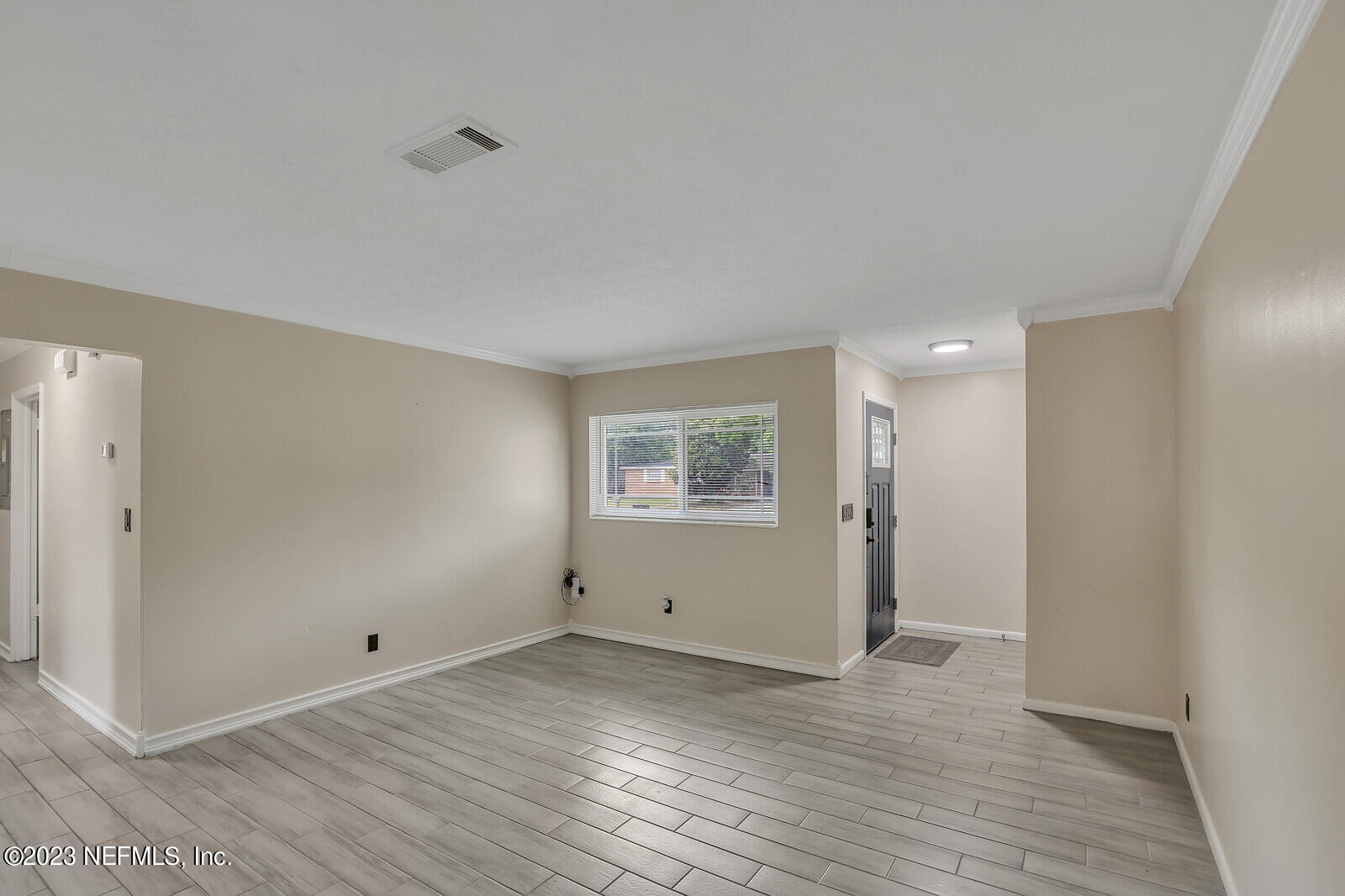 5814 Rover Drive Jacksonville, FL 32244 - Photo 13 of 30 a view of an empty room with wooden floor and a window