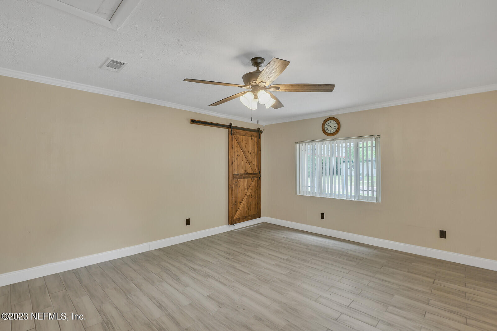 5814 Rover Drive Jacksonville, FL 32244 - Photo 21 of 30 a view of an empty room with window and wooden floor