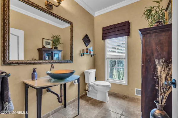 an aerial view of a house with a garden and lake view