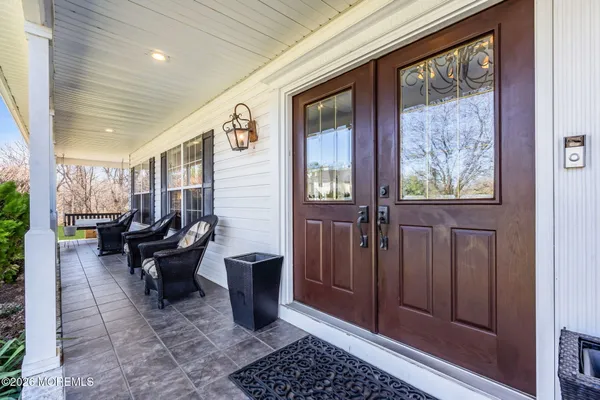 a living room with furniture and large windows