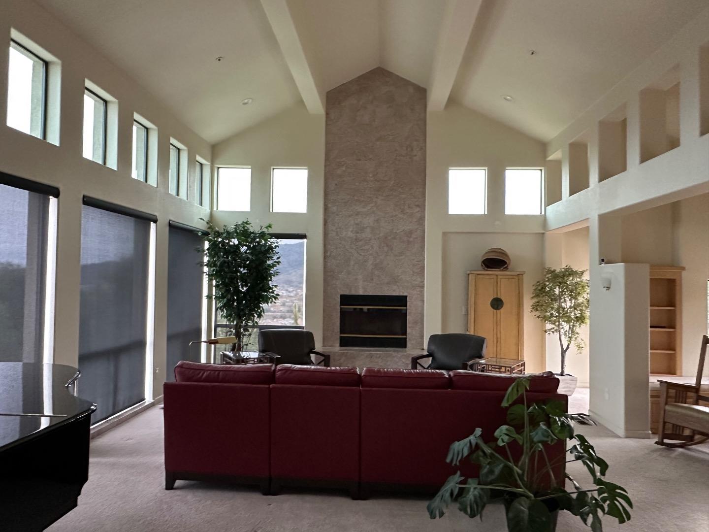 8255 Rancho Real Gilroy, CA 95020 - Photo 3 of 21 a living room with furniture a fireplace and a floor to ceiling window