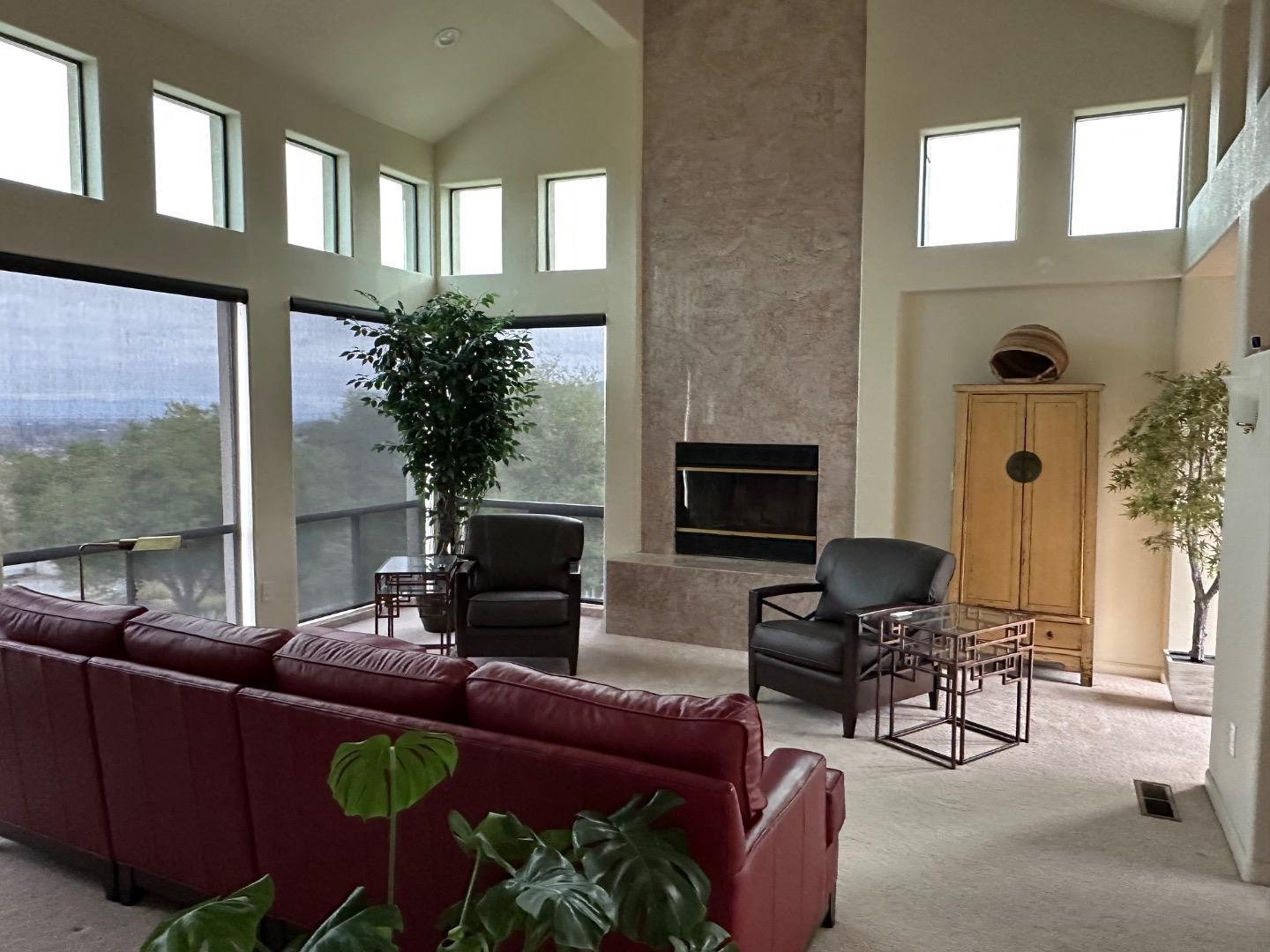 8255 Rancho Real Gilroy, CA 95020 - Photo 4 of 21 a living room with furniture a fireplace and a flat screen tv