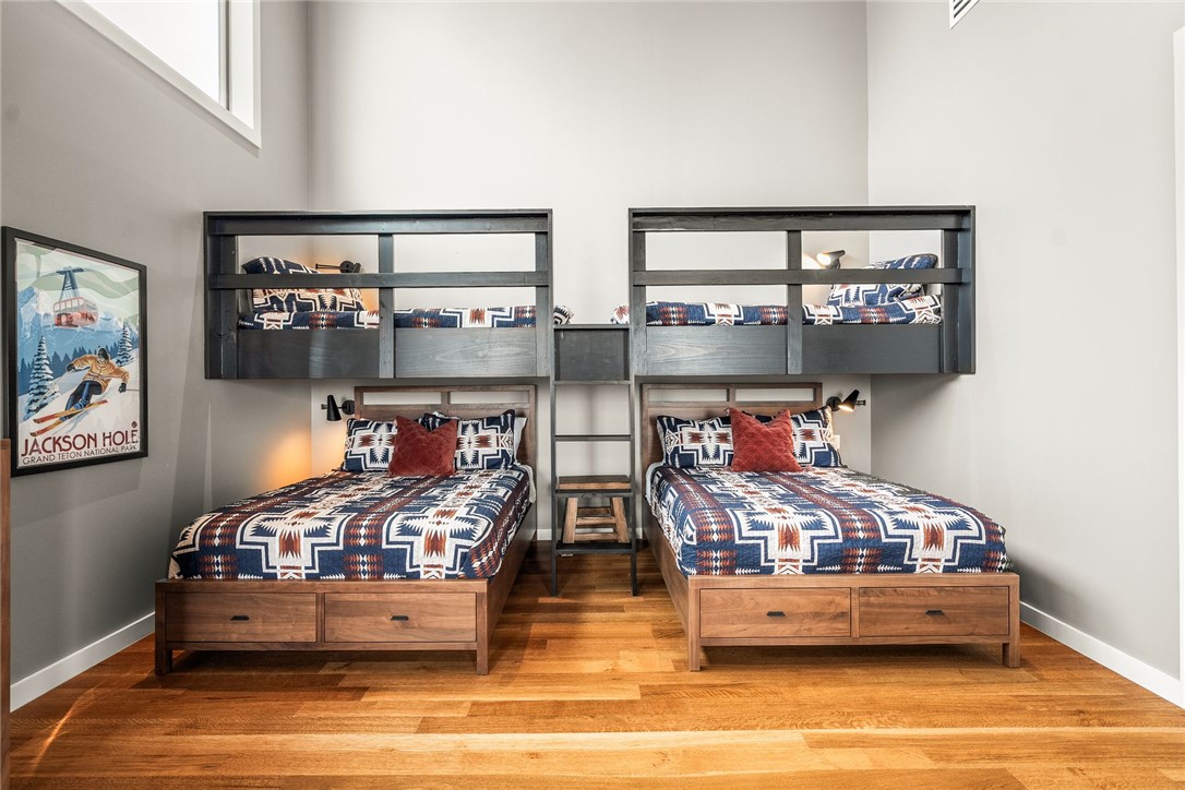2623 Alum Cave Road Bee Branch, AR 72013 - Photo 39 of 60 Spacious room featuring custom-built bunk beds with integrated ladders, durable wood-finish flooring, and high ceilings with upper windows