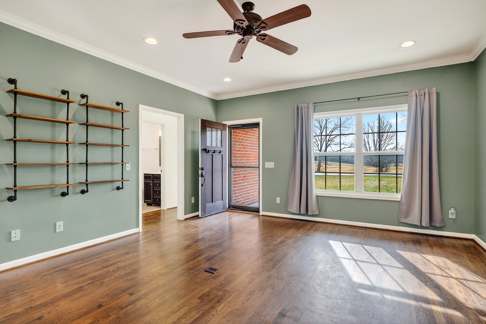 4029 Buffalo Valley Road Cookeville, TN 38501 - Photo 17 of 36 a view of an empty room with a window and wooden floor