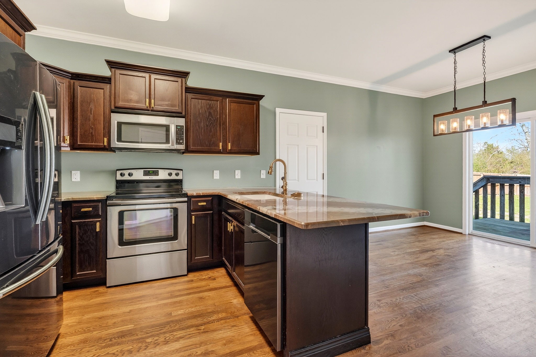 4029 Buffalo Valley Road Cookeville, TN 38501 - Photo 18 of 36 a kitchen with stainless steel appliances granite countertop a sink stove and refrigerator