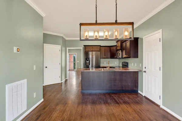 a view of kitchen and kitchen with wooden floor