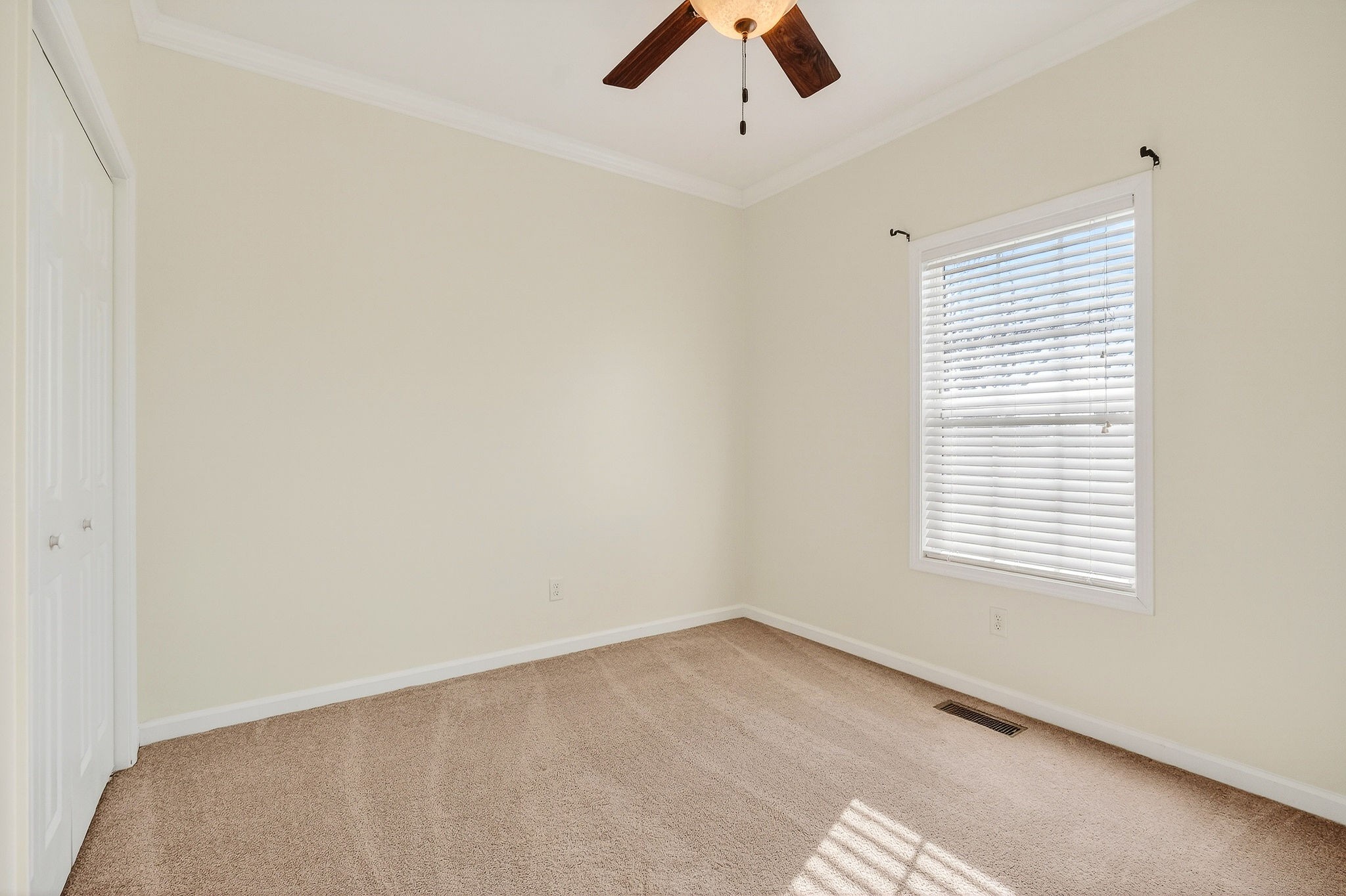4029 Buffalo Valley Road Cookeville, TN 38501 - Photo 31 of 36 an empty room with a window and a ceiling fan