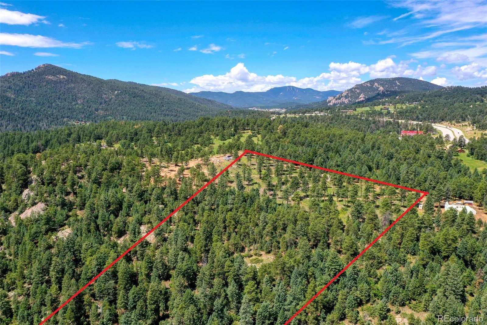 9206 Broken Bow Ranch Road Morrison, CO 80465 - Photo 11 of 15 a view of a lush green hillside and a houses