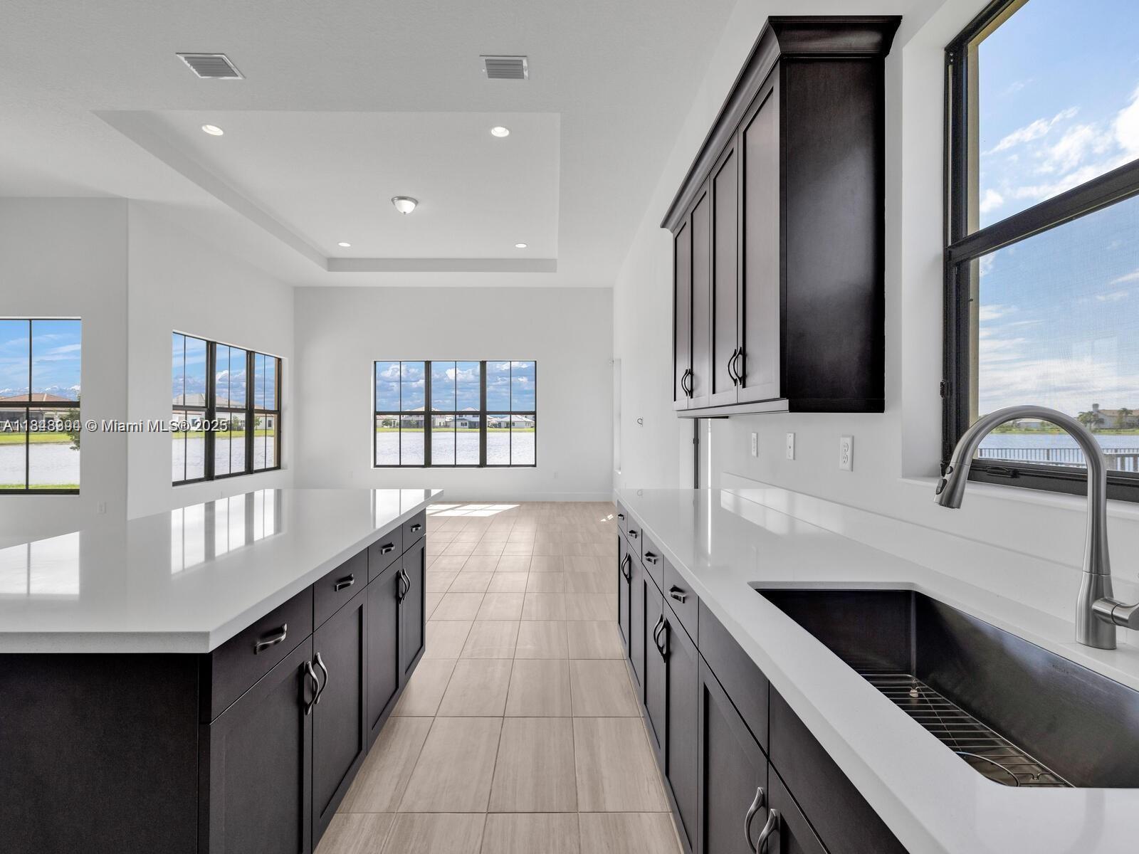 Maple Ridge Ave Maria, FL 34142 - Photo 3 of 5 a kitchen with a sink and a stove top oven