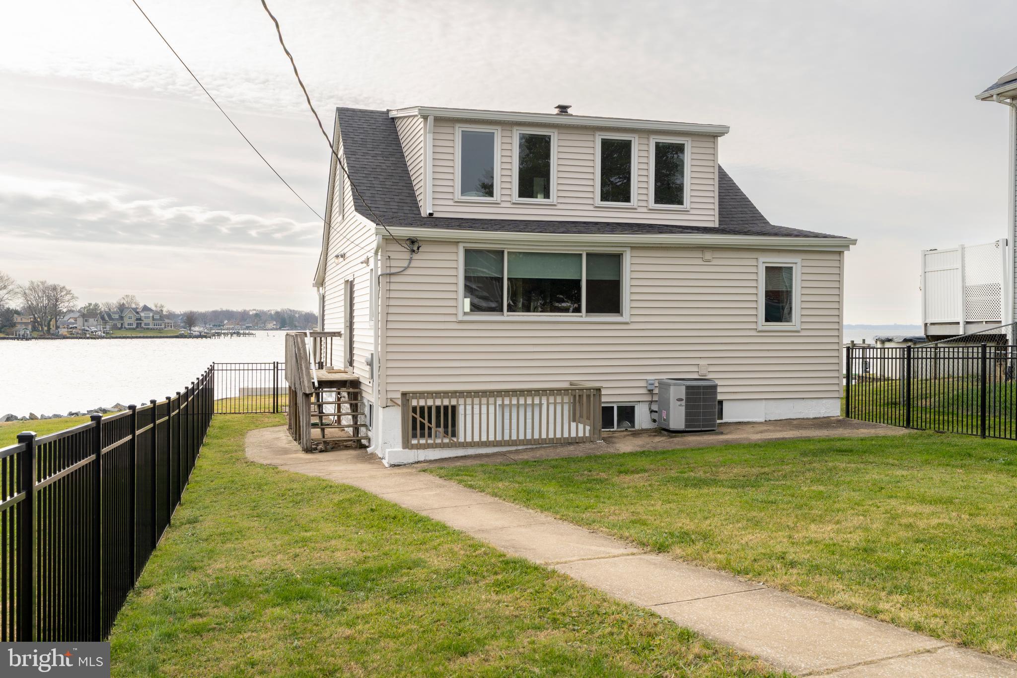 a house view with swimming pool and wooden fence