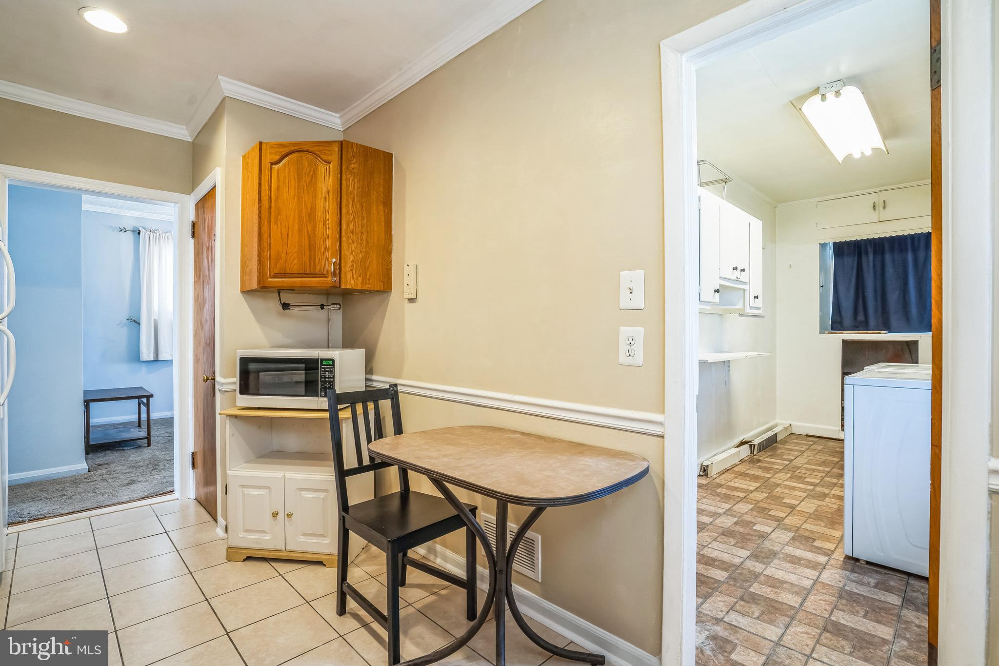 7911 35th Street Rosedale, MD 21237 - Photo 11 of 30 a kitchen with stainless steel appliances granite countertop a refrigerator and a stove top oven