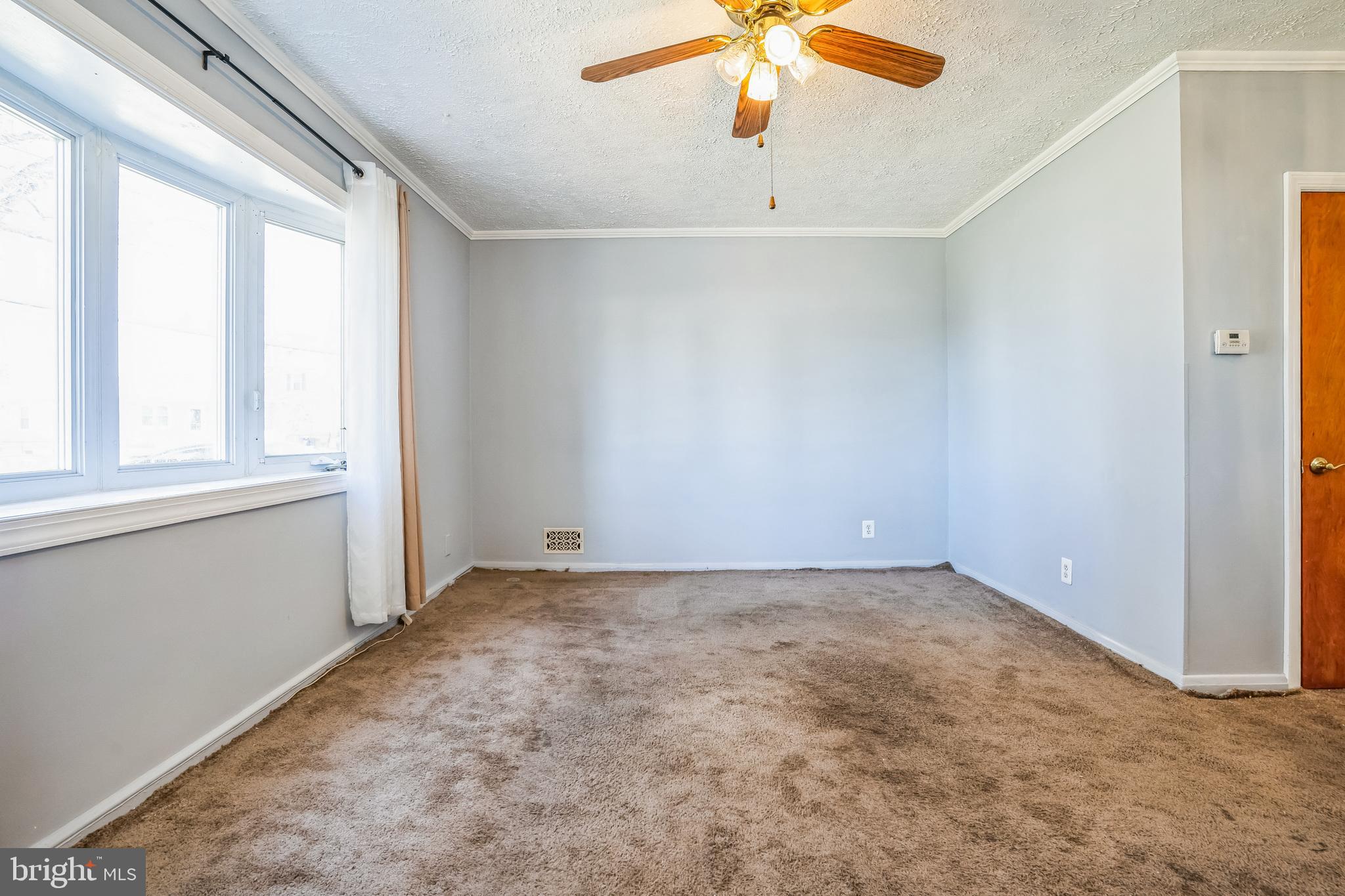 7911 35th Street Rosedale, MD 21237 - Photo 13 of 30 an empty room with a window and a ceiling fan