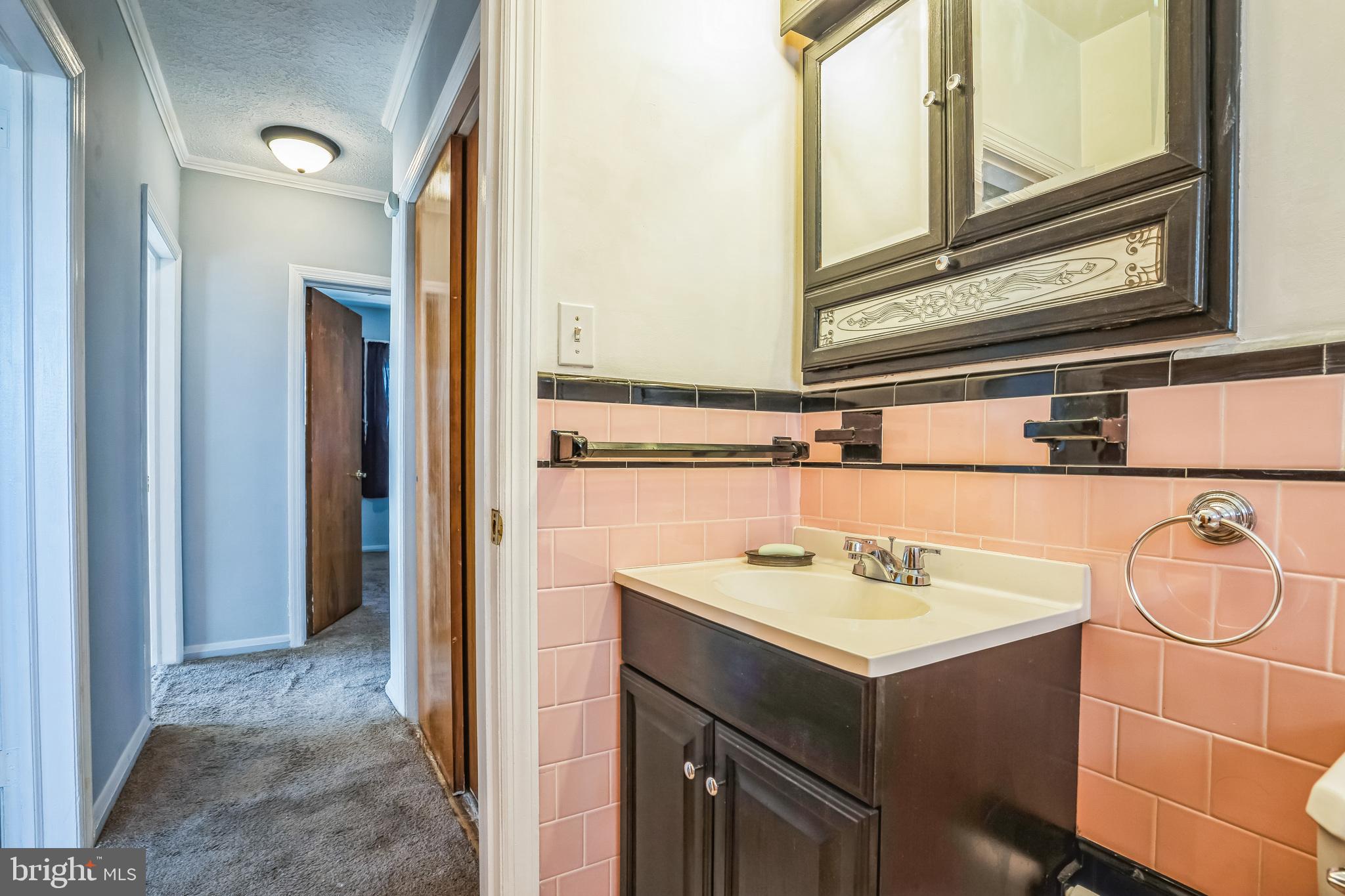 7911 35th Street Rosedale, MD 21237 - Photo 20 of 30 a bathroom with a sink vanity and a mirror